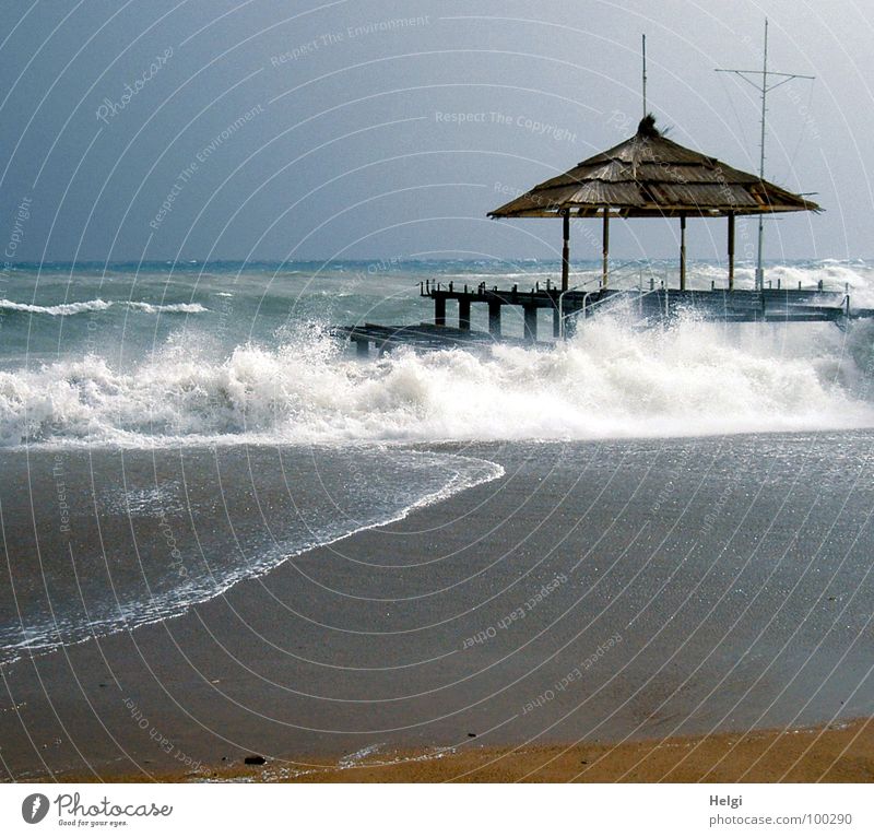 jetty with sun canopy on the beach in stormy seas Lake Ocean Waves White crest Foam Wet Flow Beach Footbridge Roof Gale Turkey Surf Brown Walking Passion