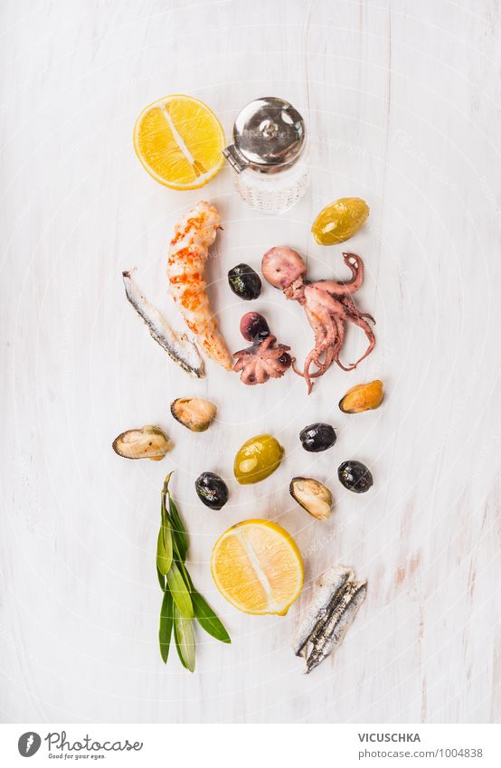 Seafood Composing with Olives and Lemon Food Herbs and spices Banquet Style Design Restaurant Octopus Shrimps anchovies Mussel Wooden table White Mediterranean