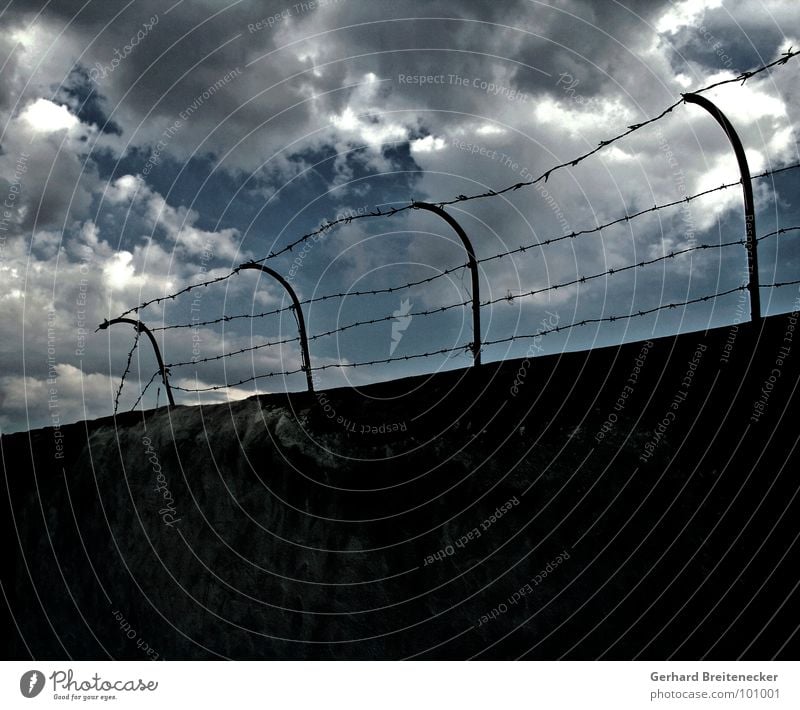 simplicity Wall (barrier) Barbed wire Clouds Thunder Border Confine Loneliness Exit route Captured Grief Distress Sky Thunder and lightning Rain Force Escape