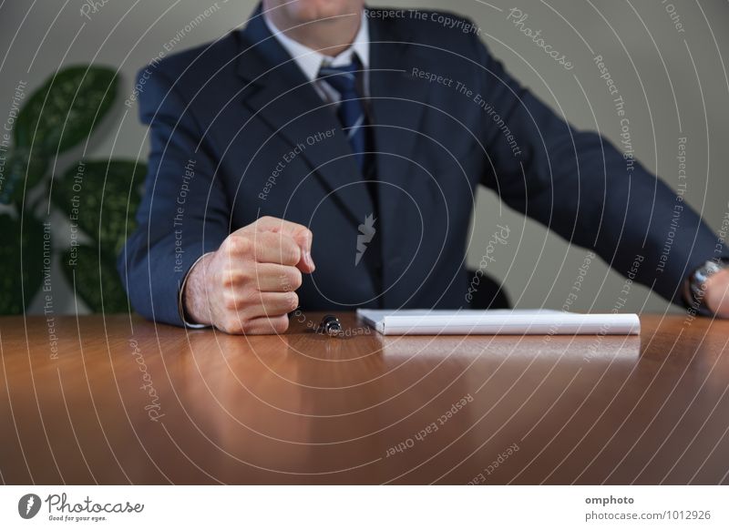 Businessman has put his fist on the table Table Office Meeting Human being Masculine Man Adults Hand 1 45 - 60 years Shirt Suit Tie Paper Pen Determination