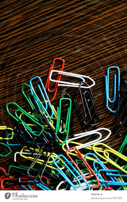 paperclip chaos Paper clip Chaos Muddled Multicoloured Wood Yellow White Reddish black Green Flexible Wire Attachment Wood grain Structures and shapes Blue