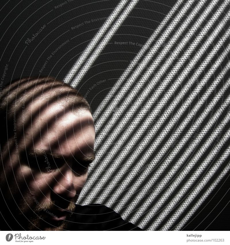 jailhouse rock Grating Venetian blinds Agency Concentrate Art Abstract Man Forehead Bald or shaved head Wall (building) Shadow play Sunlight Reading Human being