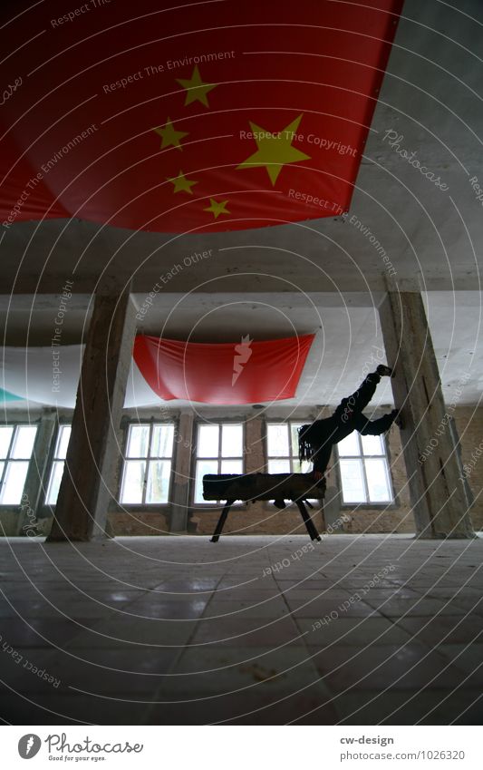 Youth doing sport on a horse - flags from the People's Republic of China hanging from the ceiling Flag younger teen Young man Man Sports Horse Red tiled
