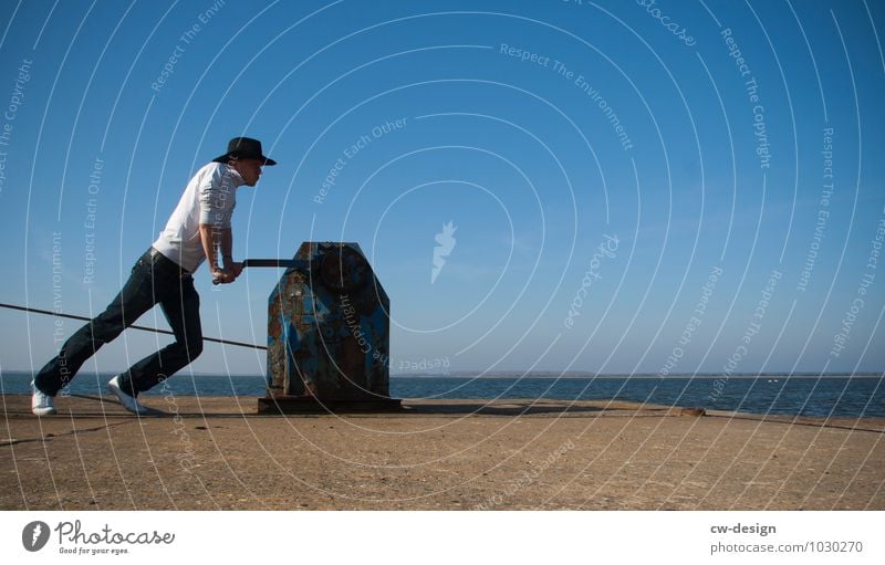 Youth with cowboy hat works in port younger Harbour Cowboy Cowboy hat Water Human being Hat Exterior shot Man Adults Summer Western Colour photo Day Sky