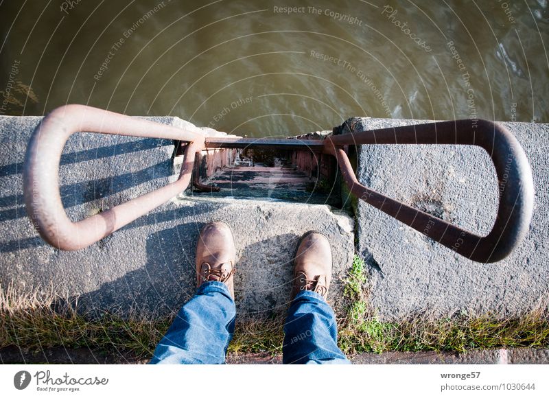 Vertical I Human being Masculine Legs 1 Harbour Wall (barrier) Wall (building) Pants Jeans Footwear Stone Concrete Water Stand Blue Brown Gray Green