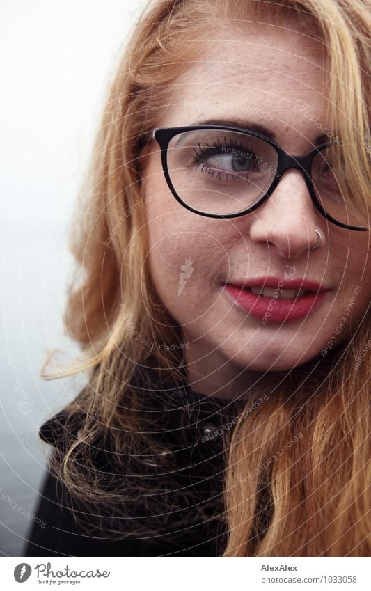 observantly Young woman Youth (Young adults) Face Freckles dimpled chin 18 - 30 years Adults Coast Coat Eyeglasses Red-haired Long-haired Watchfulness Observe