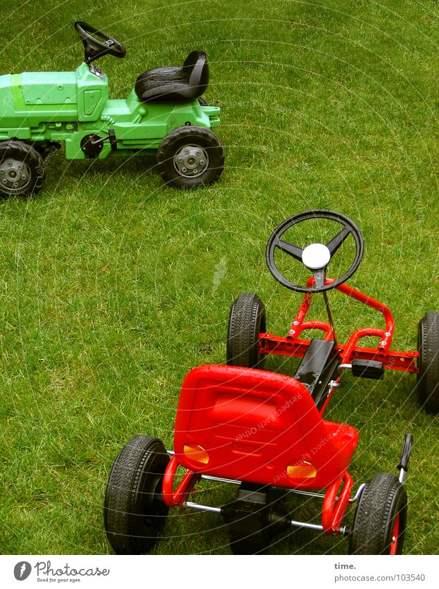 Sleeping Offroadies Colour photo Exterior shot Joy Playing Hunting Motorsports Sporting event Meadow Tractor Toys Green Red Black Passion Competition