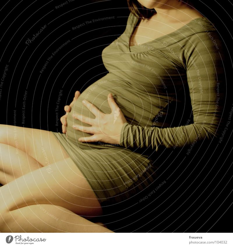 mama Woman Feminine Mother Pregnant Hand Striped Green Interior shot Emotions Touch Dress Love have a baby Feet Dark background Legs Clothing female human