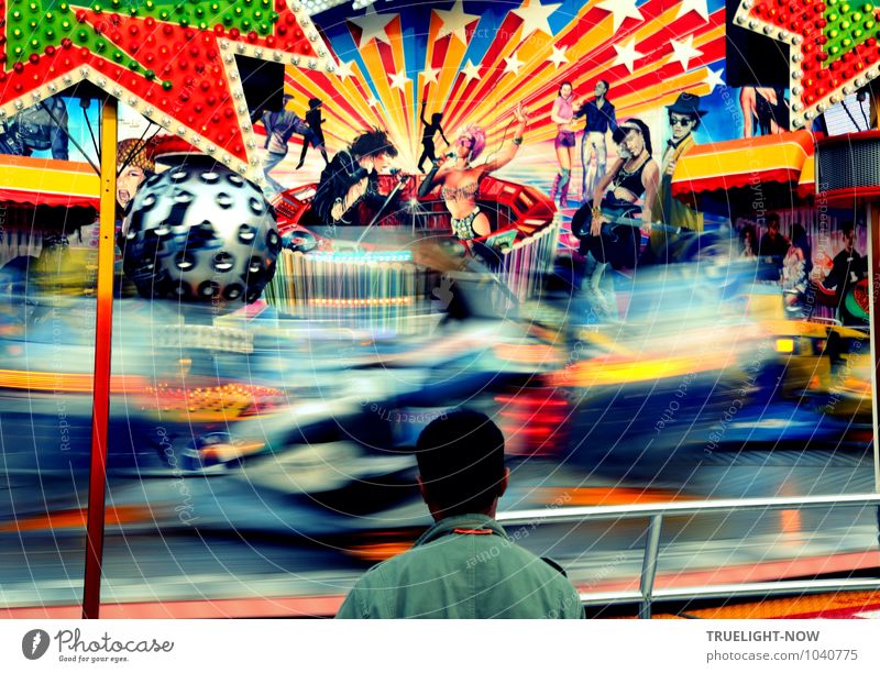 Colorful carousel in rapid ride while a lonely man stands very still in front of it and dreams Lifestyle Design Joy Happy Relaxation Leisure and hobbies