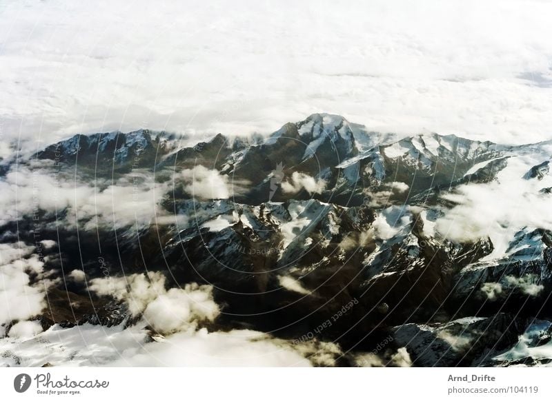 Alps Bird's-eye view Aerial photograph Airplane Glacier Clouds Bad weather Cloud cover Flying Winter Mountain Switzerland Ice Sky Landscape Stone Rock Fragment