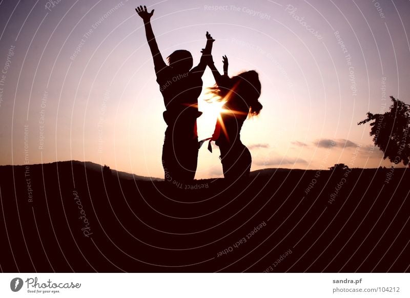 Jump up! Sunset Evening Man Woman Dark Sunbeam Silhouette Twilight Violet Pink Clouds Celestial bodies and the universe Earth Sand Dusk Human being Shadow Tall