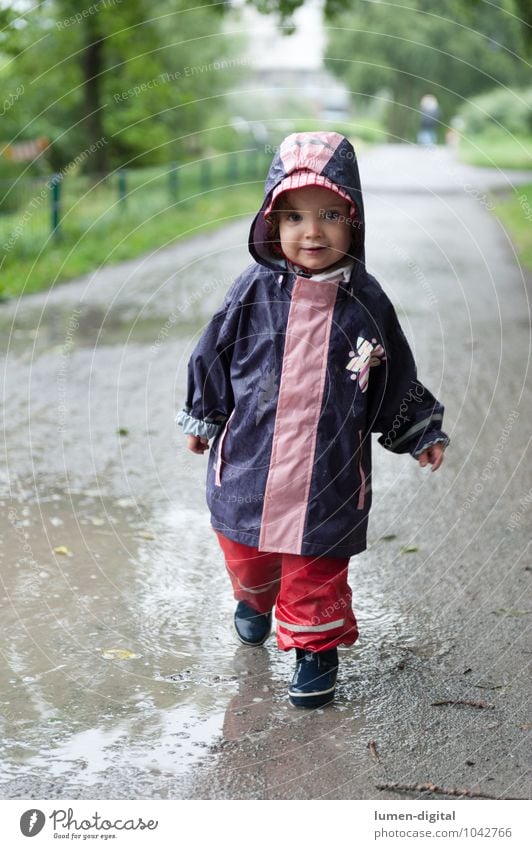 Girl in rainwear Joy Swimming & Bathing Child Toddler 1 Human being 1 - 3 years Park Rubber boots Going Laughter Stand Happiness Wet Infancy Casual clothes
