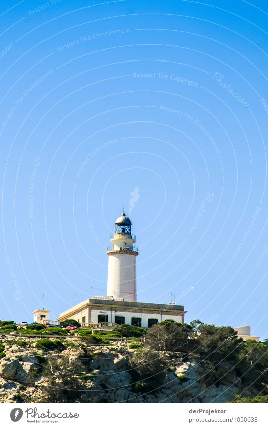 Lighthouse seen from the sea Vacation & Travel Tourism Trip Far-off places Freedom Summer vacation Mountain Environment Nature Landscape Plant Animal Hill Rock