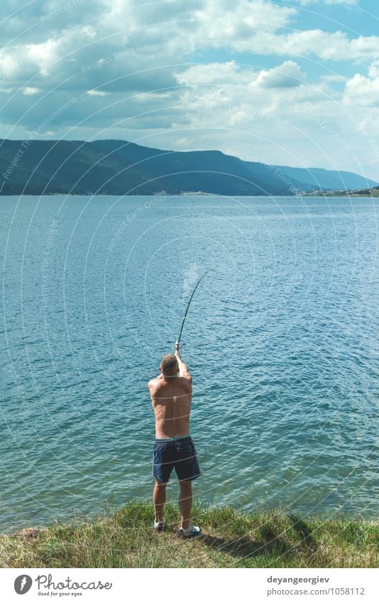 Man on fishing with rod. Mountain lake Lifestyle Relaxation Leisure and hobbies Vacation & Travel Summer Sports Human being Adults Nature Landscape Sky Lake