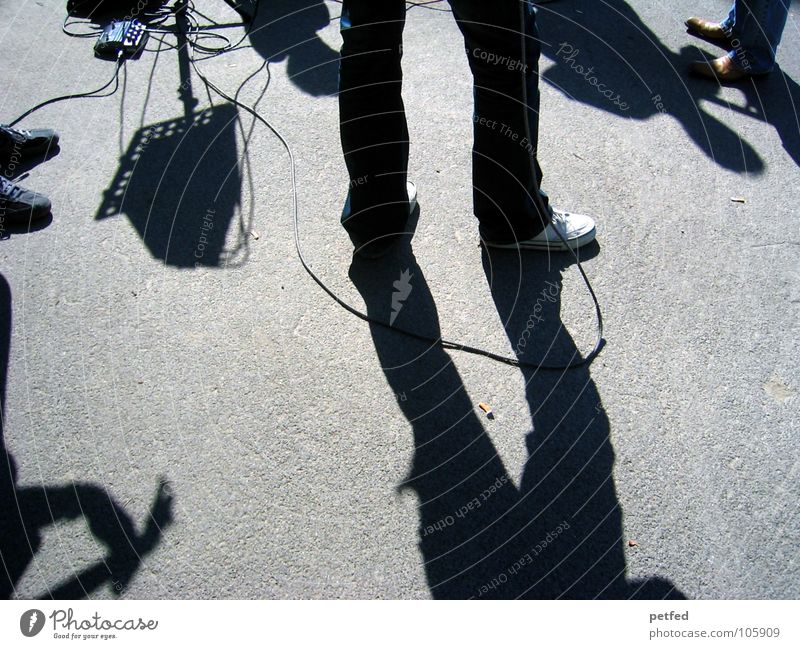 My Trip To Vienna . Leisure and hobbies Gray Footwear Musical instrument Dark White Austria Places Concert Human being black Street Guitar Shadow Sun Cable