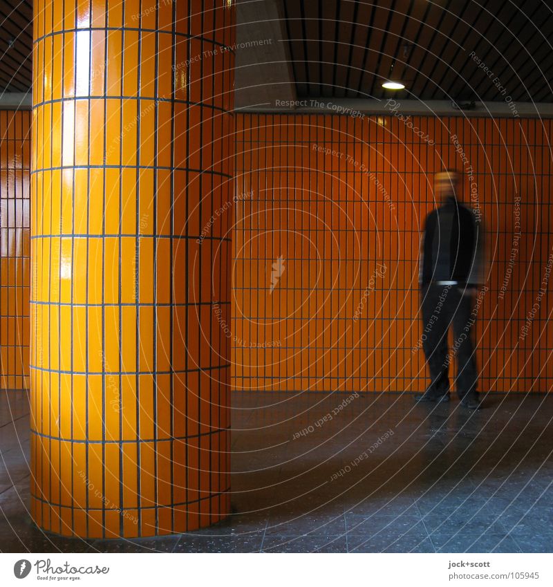 Column orange meets man Architecture Wall (building) Wait Retro Orange Emotions Loneliness Identity Tile Lighting Seventies Structures and shapes Shadow