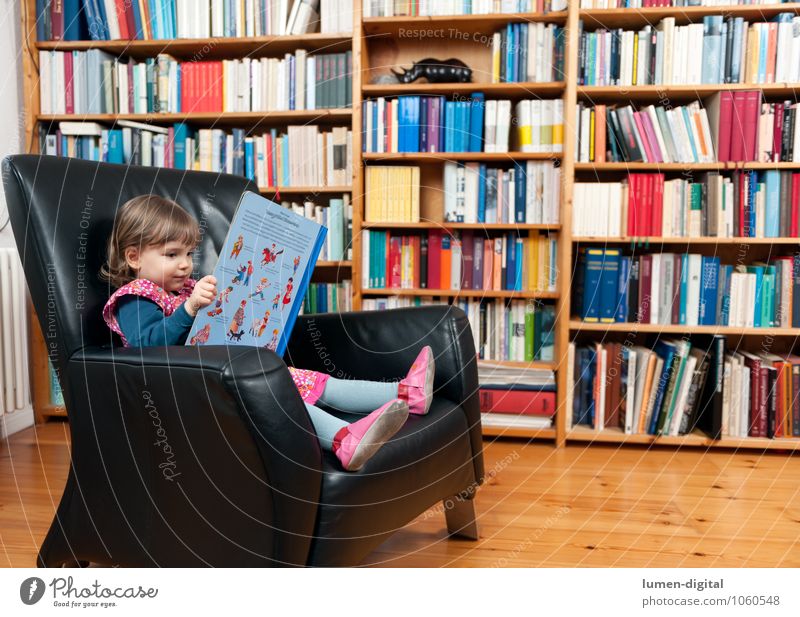 Little girl with book Reading Armchair Education Child Human being Toddler Girl 1 3 - 8 years Infancy Print media Book Library Study Living or residing look