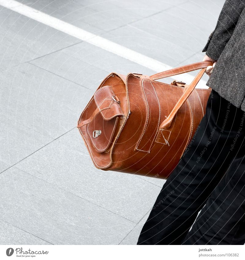 one person holds a leather travel bag in his hand Bag Traveling bag Suitcase Luggage Vacation & Travel Depart Leather Brown Man To hold on Square Carry handle