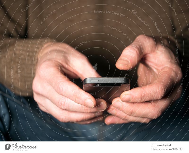 Hands with Smartphone Cellphone PDA Fingers Communicate Sit To call someone (telephone) Chat clipping device electronic hands holding jeans man sitting sweater