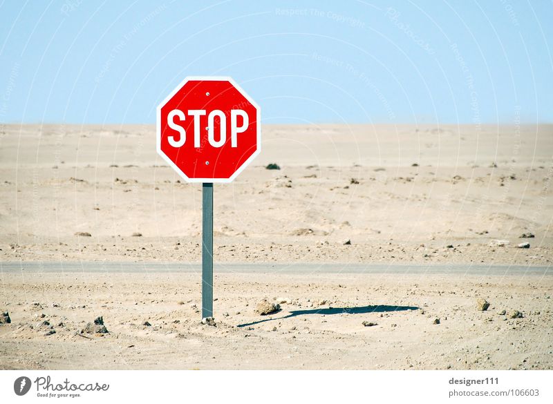 STOP Mountain Sand Climate change Drought Desert Street Lanes & trails Truck Signs and labeling Graffiti Hot Cold Above Under Blue Yellow Green Red Black White