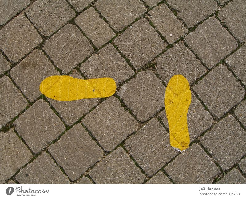 A question of direction Stride Footprint Footwear Resume Change Turn off Left Right ahead Turnaround Transform Concrete Asphalt Step-by-step Yellow Gray
