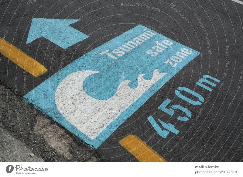 Tsunami safe zone Sign Characters Digits and numbers Signs and labeling Signage Warning sign Large Blue Yellow Black Safety Pavement Colour photo Multicoloured