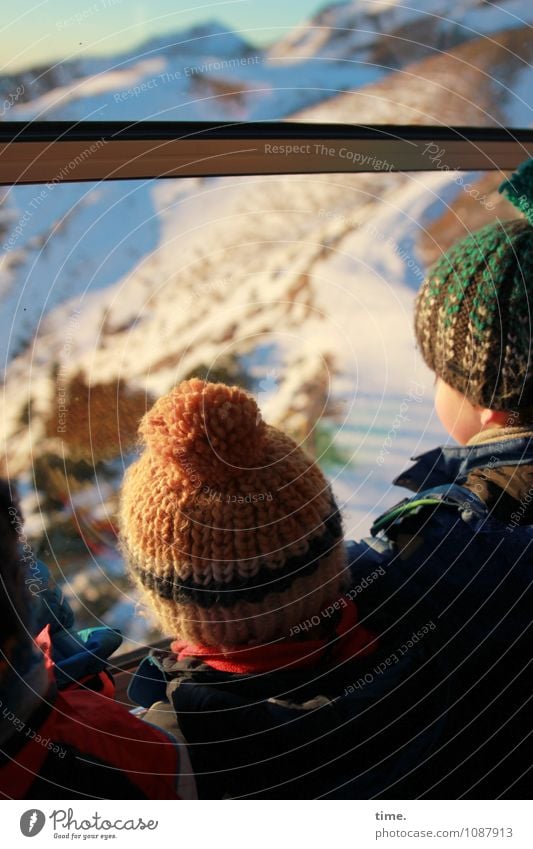 bomme express Boy (child) 3 Human being Winter Beautiful weather Snow Mountain Snowcapped peak Window Cable car Cap Woolen hat Observe Looking Stand Adventure