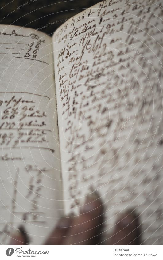 unreadable Paper Characters Old Past Text Handwriting Page Notebook Fingers Subdued colour Interior shot Deserted Day Blur Shallow depth of field