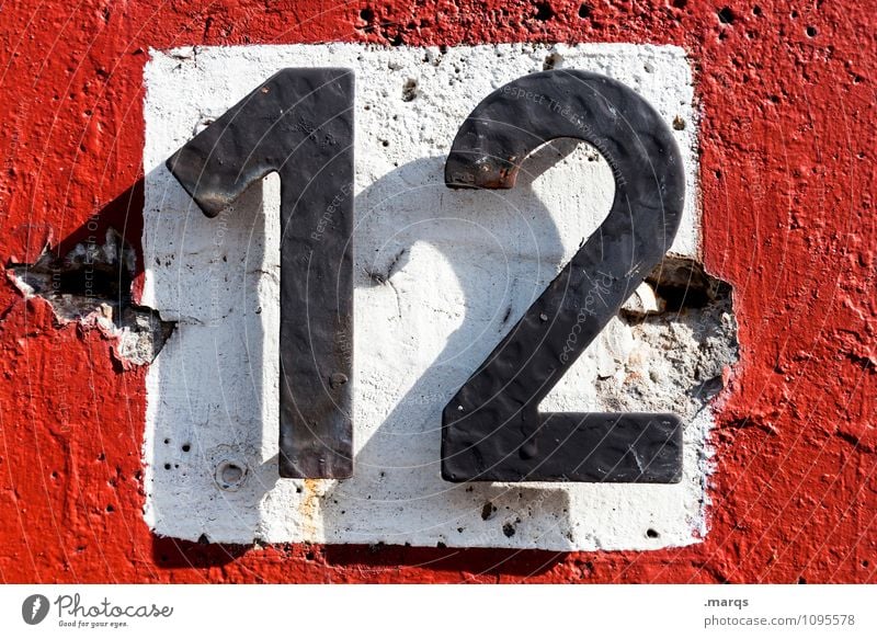12 Wall (barrier) Wall (building) Digits and numbers Simple Red Black White Age House number Colour photo Exterior shot Close-up Day Light Shadow
