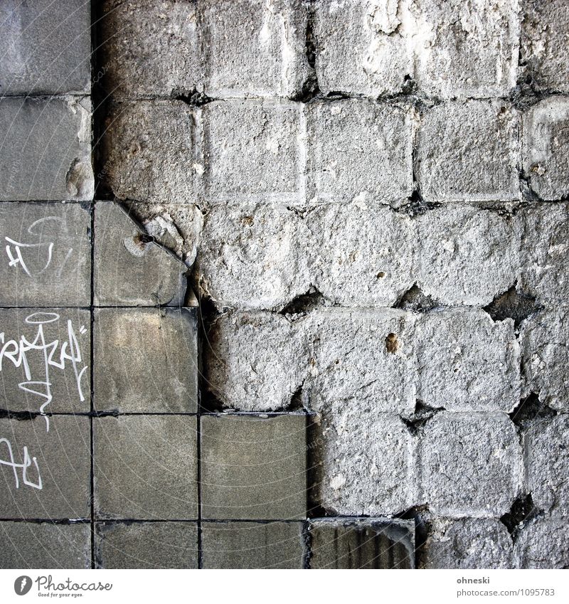 ravages of time Wall (barrier) Wall (building) Facade Tile Stone Characters Graffiti Gloomy Town Gray Colour photo Subdued colour Exterior shot Abstract Pattern