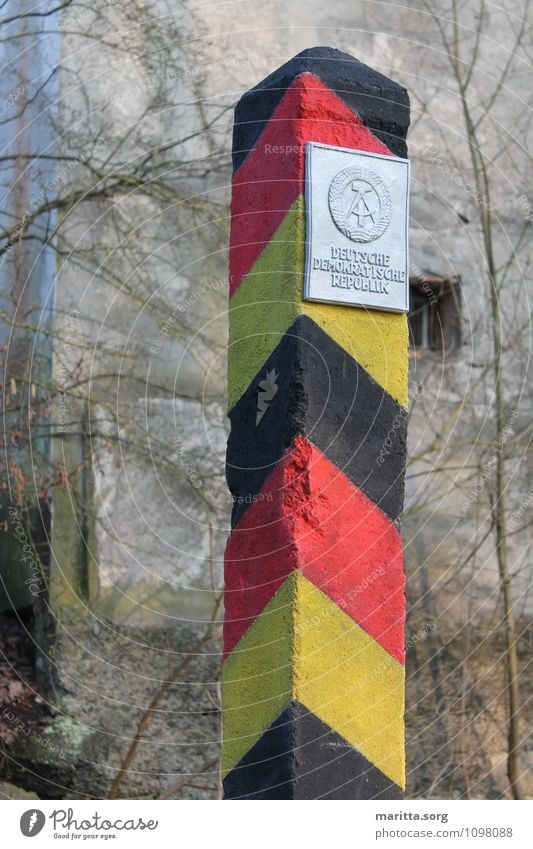 Boundary stone GDR Art Sculpture Tourist Attraction Concrete Characters Hideous Thorny Gold Red Black Might Fear Horror Competent Divide Colour photo