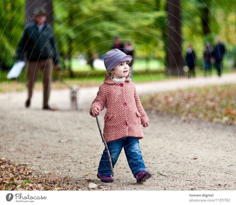 Child goes for a walk in the park Joy Hiking Human being Girl 1 1 - 3 years Toddler Nature Autumn Park Coat Cap Going Laughter Friendliness Small Movement