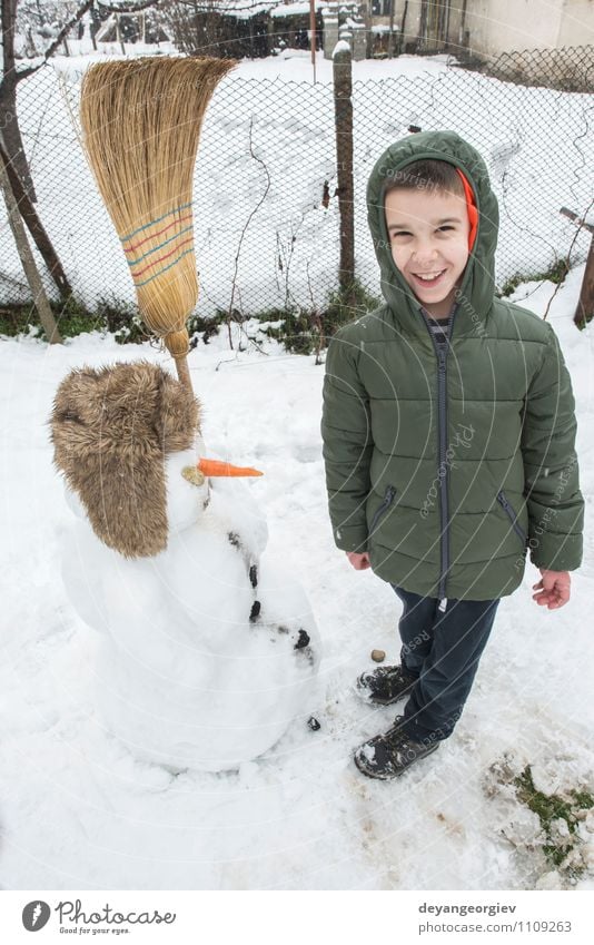 Snowman and child in the yard Joy Happy Playing Vacation & Travel Winter Child Boy (child) Woman Adults Infancy Nature Building Hat Smiling Happiness White kids
