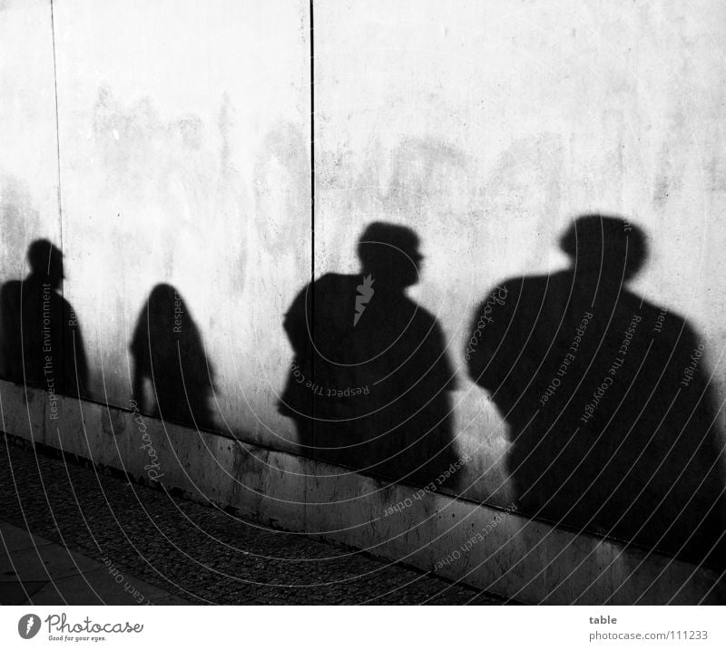 shady world Light Evening sun Man Woman Girl Concrete Wall (barrier) Wall (building) Gray Town Sidewalk Shadowy existence Shadow play Dark side Closing time