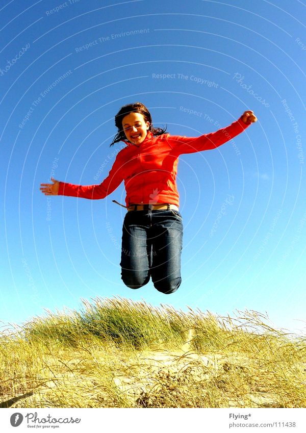 legs away Jump Airy Grass Marram grass Vacation & Travel Ocean Beach Floating Joy Summer Earth Sand Sky To fall Flying Aviation red jacket Jeans Free Fall