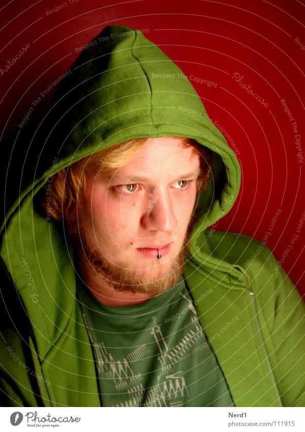 Angry?am i? Green Man Hooded (clothing) Red Concentrate Eyes Face Looking Looking away Face of a man Piercing Blonde Goatee Hooded jacket Earnest Observe