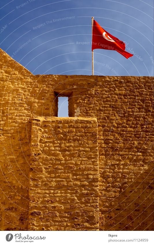 flag in the w Sky Clouds Castle Flag Blue Brown Red White wall tunisi Tunisia brick window Colour photo