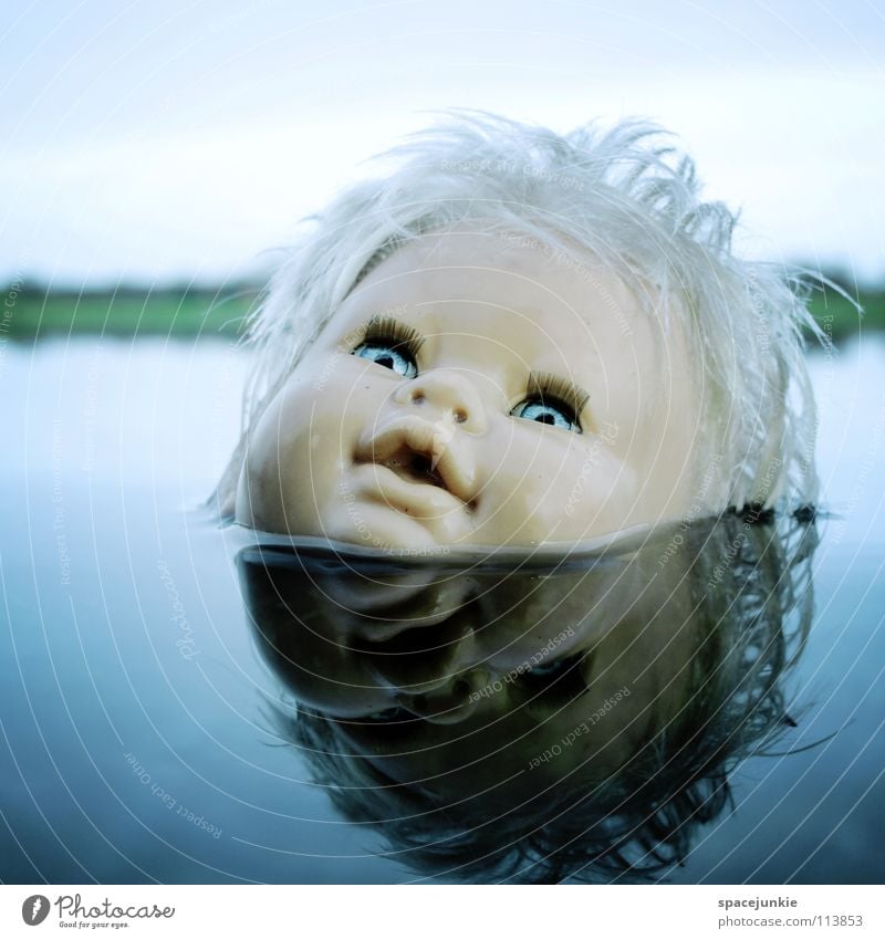 In the water Toys Threat Alarming Blonde Chucky Creepy Horror film Evil Sweet Cute Whimsical Lake Ocean Wet Joy Doll Eyes Blue Fear Wild animal