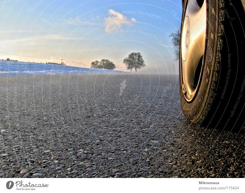 on the road Winter Snowscape Afternoon Afternoon sun Evening sun Street Fog Pavement Motor vehicle Car Tire Wheel Wheel cover Sky Landscape Country road