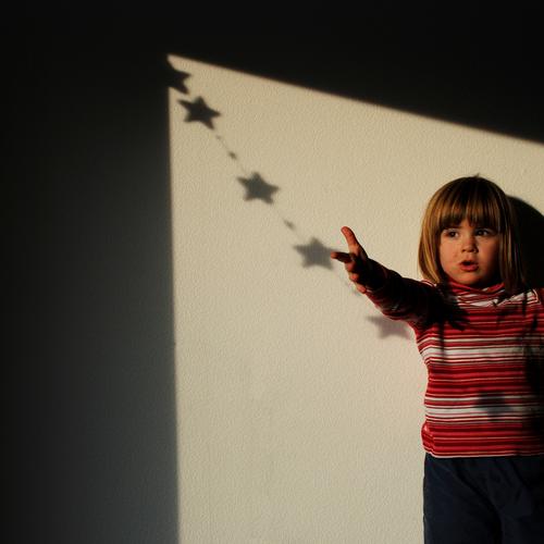 christmas child Child Girl Portrait photograph Emotions Christ child Christmas & Advent Star (Symbol) To hold on Lamp Shadow Catch Moon Tradition