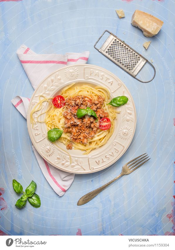Spaghetti bolognese, composing on blue wooden table Food Meat Cheese Vegetable Dough Baked goods Herbs and spices Cooking oil Nutrition Lunch Organic produce