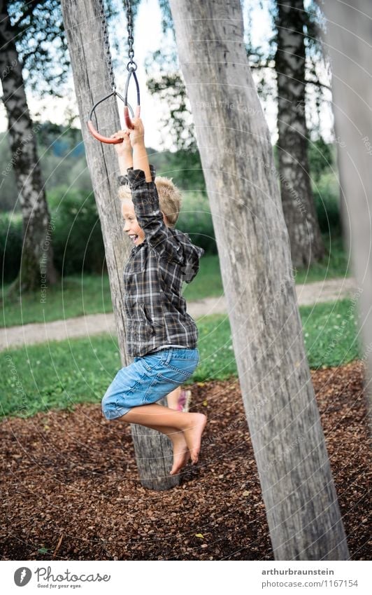Boy swinging with rings Athletic Leisure and hobbies Playing Playground Circle Vacation & Travel Tourism Trip Summer Summer vacation Garden Fitness
