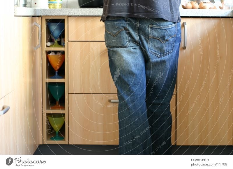 Even the man is Man Masculine Kitchen Cooking Nutrition Cupboard eugen Food Emancipation Legs Hind quarters Jeans Detail