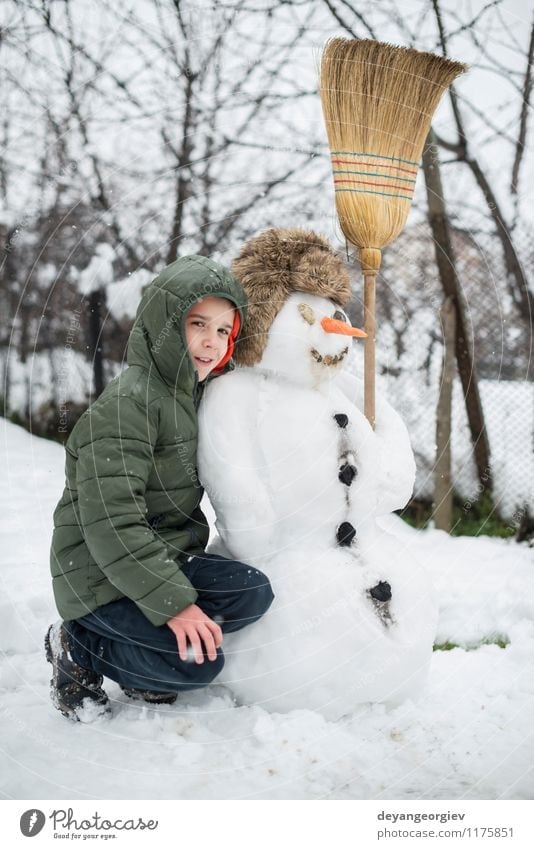 Snowman and child in the yard Joy Happy Playing Vacation & Travel Winter Child Boy (child) Woman Adults Infancy Nature Building Hat Smiling Happiness White kids