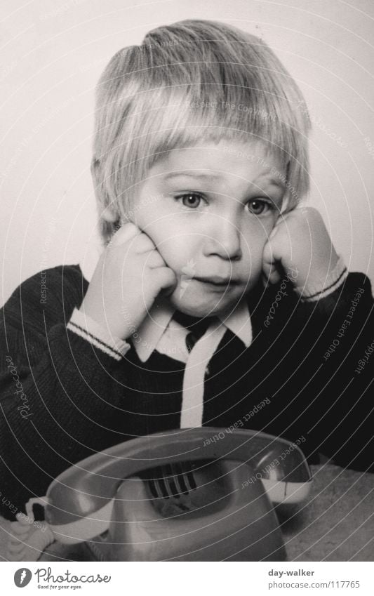 She's not calling. Child Telephone Boy (child) Blonde Jacket Exasperated To call someone (telephone) Retro Toys Hair and hairstyles Boredom Old Sadness