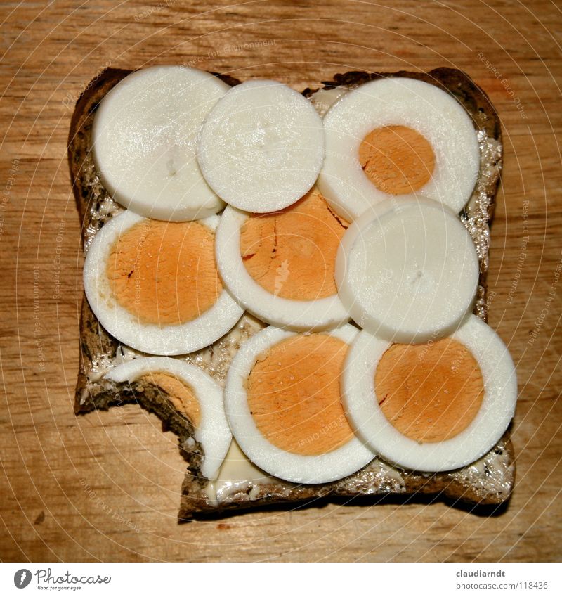 A bite Sandwich Bread Dinner Breakfast Chopping board Yolk Meal Nutrition Food Circle Geometry Part Attempt Full Butter Egg egg sandwich Haircut yellowish-white