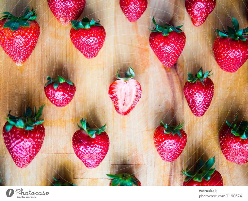 One cut strawberry in an arranged pattern of strawberries Fruit Strawberry Nutrition Board Design Summer Decoration Wood Authentic Exceptional Fresh Healthy