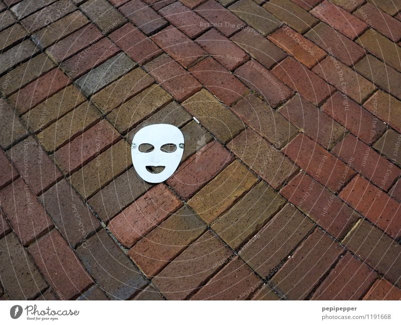 mask Androgynous Infancy Eyes Mouth Town Terrace Street Lanes & trails Mask Paper Stone Sign Masked ball Laughter Lie Red White Joy Loneliness Exterior shot