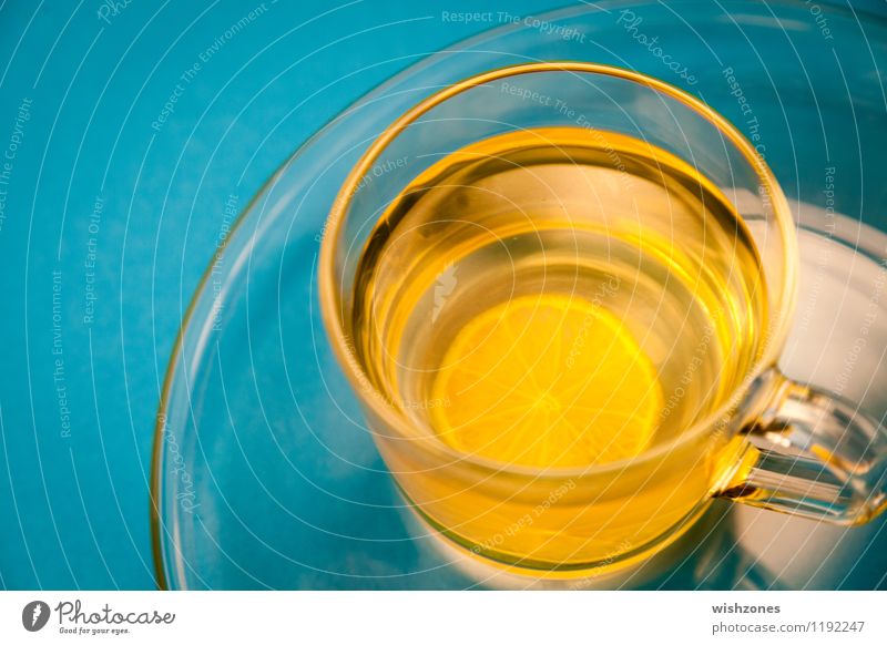 Lemon Tea in a Glass with blue Background Fasting Beverage Plate Cup Healthy Wellness Harmonious Well-being Yellow cup of tea lemon tea Blue Blue background
