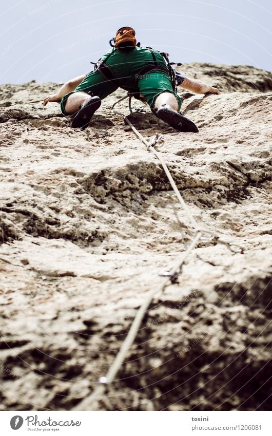 Young man climbing up a mountain on a rope 1 Human being Athletic Climbing Strong Weight training Force Sportsperson Climbing rope Climbing shoes